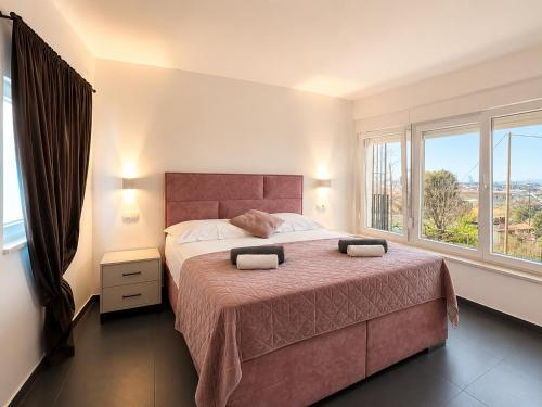 a bedroom with a large bed with a large window at AAA Luxury Suites Split with Pool in Split
