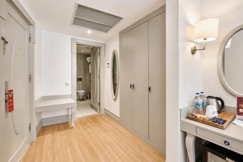 a bathroom with a hallway with a sink and a mirror at Faros Hotel Old City - Special Category in Istanbul