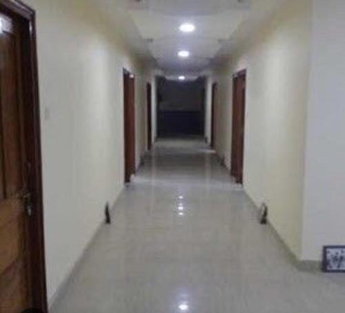 an empty hallway of a building with a long corridor at hotel gsa & guest house in Haridwār