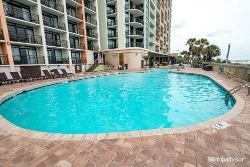 a large swimming pool in front of a building at Condos at the Caribbean Resort in Myrtle Beach