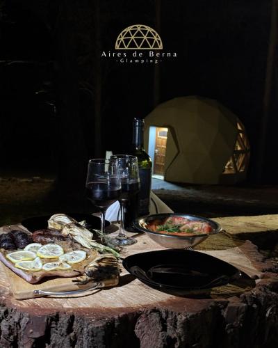 a table with food and glasses of wine on it at Aires de Berna in Villa Berna