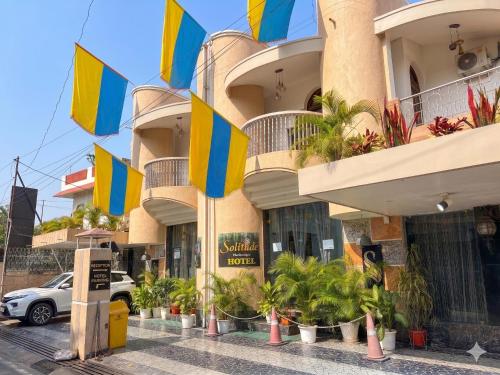 a building with colorful flags in front of it at Solitude, The Boutique Hotel- Ultra Luxurious in Haldwāni