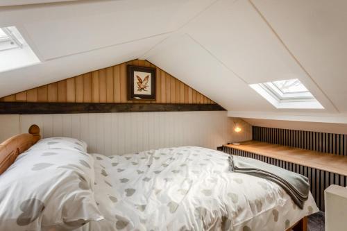 a bedroom with a bed in a room with skylights at 1 Bed in Tilbrook oc-a40241 in Tilbrook
