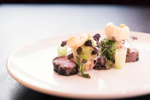 a white plate with food on a table at Montcalm Royal London House, London City in London