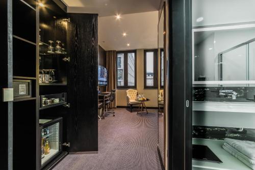 a kitchen with a stove, sink, and refrigerator at Montcalm Royal London House-City of London in London