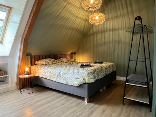 a bedroom with a bed and a ladder and lights at De Buitenhof in Marknesse