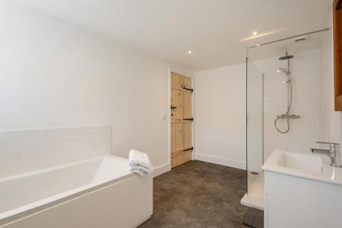 a bathroom with a tub and a sink and a shower at 1 Bed in Barrow oc-b42640 in Barrow