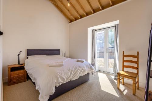 a bedroom with a bed and a chair and a window at 2 Bed in Barrow oc-b42642 in Barrow