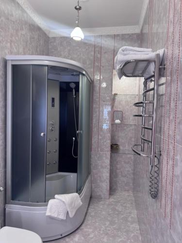 a bathroom with a large mirror and a shower at Liders17 in Odesa