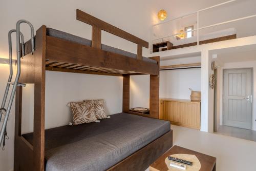 a bedroom with a bunk bed and a desk at Jo&Co Mykonos Nature Suites N3 in Plintri