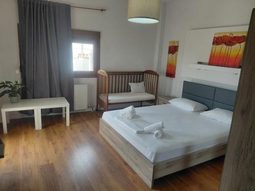 a bedroom with a bed and a couch and a chair at Vista Mare in Nea Irakleia