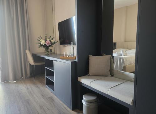 a bedroom with a desk and a bed with a mirror at Uma Premium in Ulcinj
