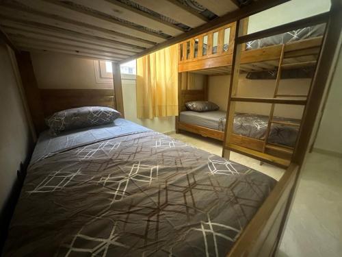 a bedroom with a bed and bunk beds at Stars Hostel Tangier in Tangier