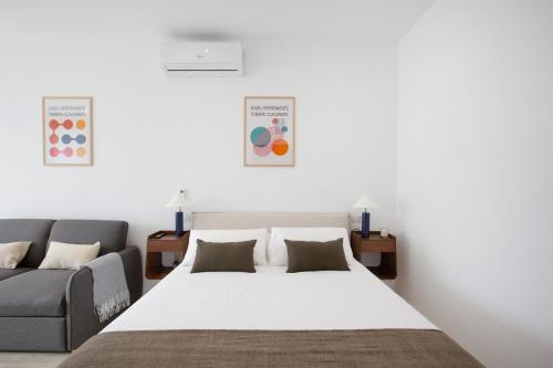 a bedroom with a large bed and a couch at Urbil Puente Colgante in Portugalete