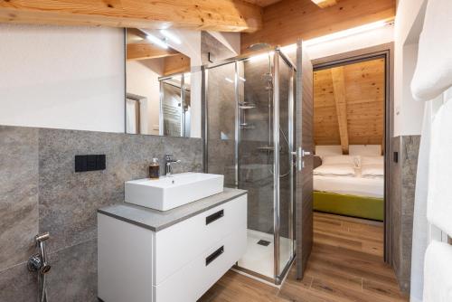 a bathroom with a sink and a shower at ChaletMafi in Valdidentro