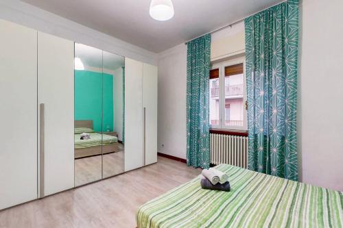 a bedroom with a bed and a mirror at [AltaVista] Acqui sotto, cielo sopra il letto in Acqui Terme