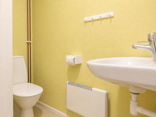 a bathroom with a sink and a toilet at Solbacka apartments Norr - Panorama view in Södra Ås