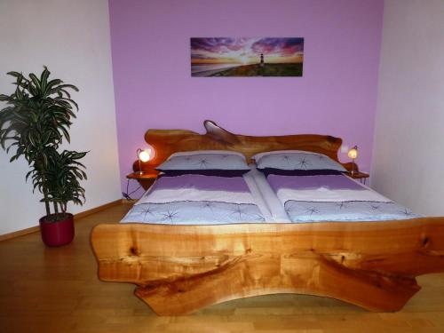 a bedroom with a wooden bed with a wooden headboard at Lehnerhof in Grossraming