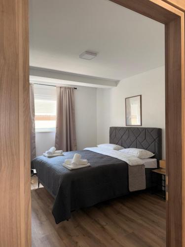 a bedroom with a bed with two towels on it at Apartman Andrea in Posušje