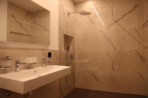 a bathroom with a sink and a shower at Rhein Suites in Eiken