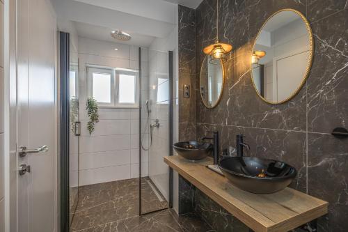 a bathroom with two sinks and a shower at Villa Collis in Makarska