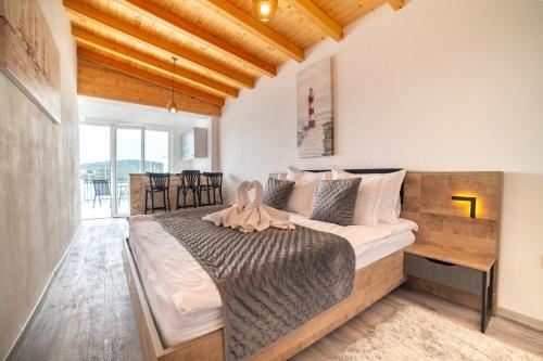 a bedroom with a large bed with a wooden headboard at Black Pearl Tisno in Tisno