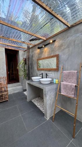 a bathroom with a sink and a mirror at Alibaba Bungalows in Gili Islands