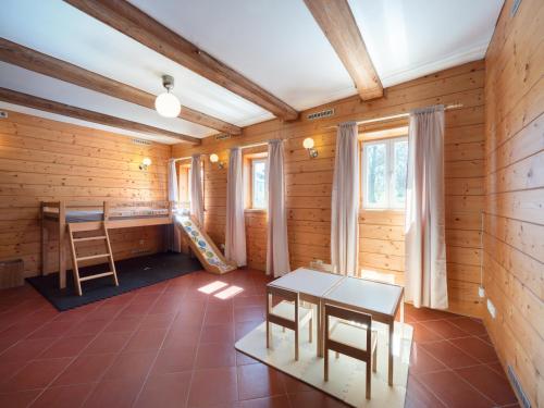 a room with a table and a ladder in it at Chalupa Domovina in Jiřetín pod Jedlovou