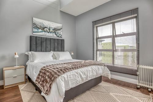 a bedroom with a large bed and a window at The Link Sandton Apartment in Johannesburg