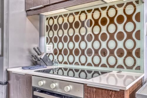 a kitchen with a sink and a mirror at The Link Sandton Apartment in Johannesburg