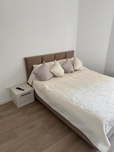 a bedroom with a bed with pillows on it at Aria & Boris Apart Kogalniceanu in Oradea
