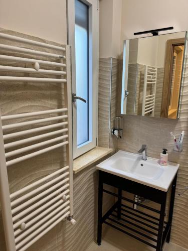 a bathroom with a sink and a mirror at B&B Capo Vaticano Stay in Capo Vaticano
