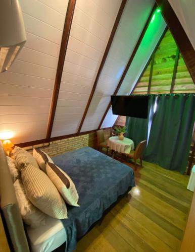 a bedroom with a bed and a large window at Pousada Beach House Coqueirinho in Jacumã