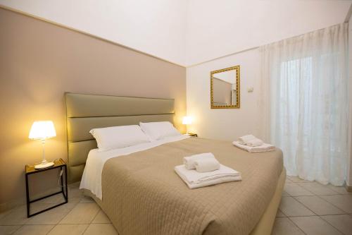 a bedroom with a large bed with towels on it at Dimora del Murattiano in Monopoli