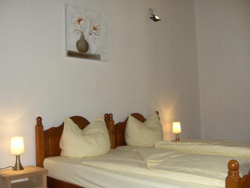 two beds with white pillows and a picture on the wall at CasaBelaVista II in Pedreira