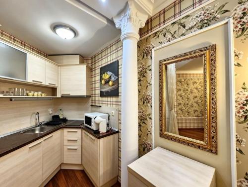 a kitchen with a sink and a mirror at Europroperties Zlatna Kotva Apartments in Golden Sands