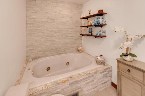 a bath tub in a bathroom with white walls at Fireplace Fire Pit Ski 5 Mountains 4BR Views in Thornton