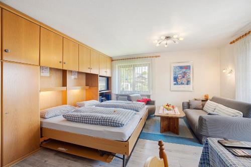 a bedroom with a large bed and a couch at Ferienwohnung Vogel in Wertach