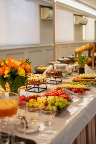 a buffet line with many different types of food at Biazi Plaza Hotel Bauru in Bauru