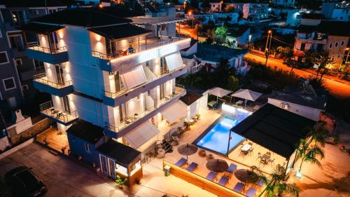 an aerial view of a building with a swimming pool at night at Zogaj Hotel in Ksamil