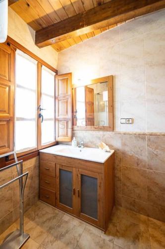 a bathroom with a sink and a mirror at Fuente Buelna By Silastur in Buelna