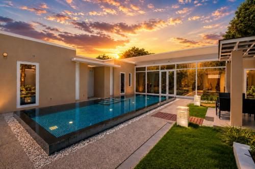 a swimming pool in the backyard of a house at Sunshine Beach Villa Mai Khao in Mai Khao Beach