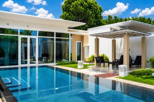a swimming pool in the backyard of a villa at Sunshine Beach Villa Mai Khao in Mai Khao Beach