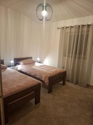 a bedroom with two beds and a chandelier at Holiday Home Izabela in Kršan