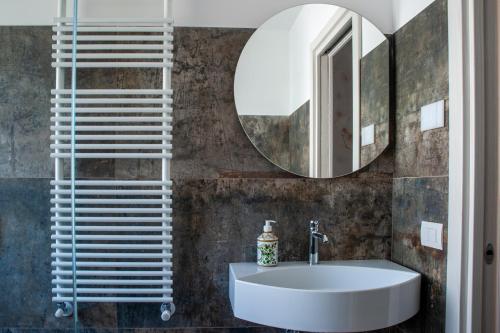 a bathroom with a sink and a mirror at Bastian B&B in Sarmede