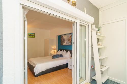 a bedroom with a bed and a book shelf at House Goran in Crikvenica