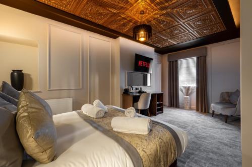 a hotel room with a bed and a tv at The Kings Arms Hotel in Berwick-Upon-Tweed