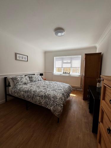 a bedroom with a bed and a window at Home in Greatstone in Greatstone