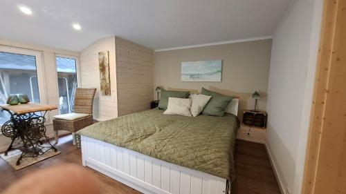 a bedroom with a large bed in a room at Bungalow am Wald in Coswig