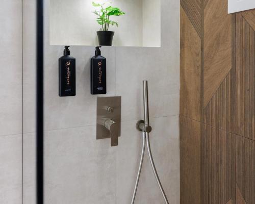 a bathroom with two black bottles on the door at Ciel Collection - Luxury Seafront Living in Perea